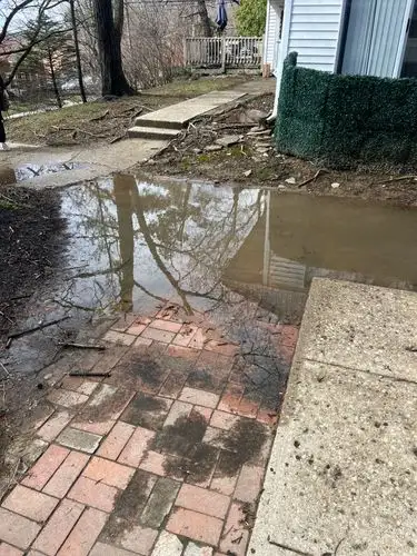 Reflections of a soggy day on a wet brick path.